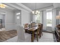 Open dining area with wood flooring, crown molding, and large windows with natural light at 409 Grading Stick Ct, Angier, NC 27501