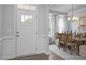 Welcoming foyer featuring a white door, wood floors, and trim work, leading into the dining area at 409 Grading Stick Ct, Angier, NC 27501