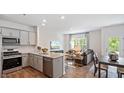Open floor plan with kitchen, living, and dining areas, and modern decor throughout at 456 Belgian Red Way, Wake Forest, NC 27587