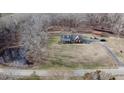 An elevated shot highlights the home's pond, driveway, and its serene wooded surroundings at 466 Oren Gaines Rd, Goldston, NC 27252