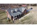 Aerial shot showcasing the home's roof, red shutters, manicured landscaping, and mature trees at 466 Oren Gaines Rd, Goldston, NC 27252