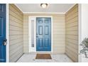 A well-lit front door with a fresh coat of paint and a welcome mat at 5017 Pine Cone Dr, Durham, NC 27707