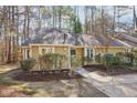 Single-story home featuring a landscaped front yard with mature trees at 5017 Pine Cone Dr, Durham, NC 27707