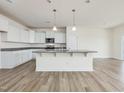 Kitchen with granite countertops, white cabinets, stainless steel appliances, and island with sink at 556 Winding Creek Dr Dr, Lillington, NC 27546