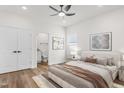 Serene bedroom featuring a comfortable bed, ceiling fan and an adjacent bathroom with modern fixtures at 603 Lee St, Burlington, NC 27217