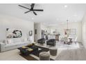 Bright open-concept living area with modern decor, including a stylish sofa, chairs, and a sleek kitchen at 605 Lee St, Burlington, NC 27215