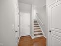 Entryway with hardwood flooring, stairs with white risers, and a neutral color palette at 711 Keystone Park Dr # 51, Morrisville, NC 27560