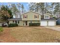Charming two-story home with a welcoming front yard and a two-car garage at 7612 Harps Mill Rd, Raleigh, NC 27615