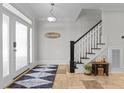 Bright foyer with a staircase and decorative rug creates a welcoming entrance at 818 Cabin Creek, Pittsboro, NC 27312