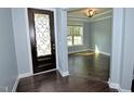 Bright entryway featuring a decorative front door, hardwood floors, and an open view to an adjacent room at 905 Maynard Creek Ct, Cary, NC 27513