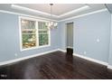 Bright living room with hardwood floors, tray ceiling, and fresh paint at 905 Maynard Creek Ct, Cary, NC 27513