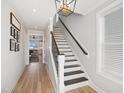 Inviting foyer showcases a staircase with wooden treads, iron spindles, and light hardwood floors at 140 Big Barn Dr, Wendell, NC 27591