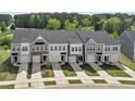 Aerial view of modern townhomes showcases well-manicured lawns and coordinated color schemes at 156 Fideaux Blvd # 248, Raleigh, NC 27603