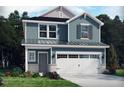 Charming two-story home with a two-car garage, landscaped yard, and tasteful exterior paint at 2019 Cherry Creek Rd, Haw River, NC 27258