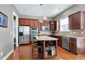 Modern kitchen featuring stainless steel appliances, granite countertops, and a center island with storage at 2109 Royal Berry Ct, Cary, NC 27511