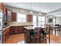 Spacious kitchen with an island, stainless steel appliances, and a view of the dining area at 2109 Royal Berry Ct, Cary, NC 27511