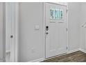 Bright entryway with a white door featuring glass panes and a smart lock, and neutral wall paint at 2241 Horton Park Dr, Apex, NC 27539