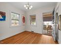 Inviting room featuring hardwood floors and access to an outdoor screened-in porch at 2610 University Dr, Durham, NC 27707