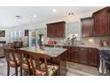 Well-equipped kitchen with granite counters, cherry cabinets, and an island with a breakfast bar at 4204 Vineyard Ridge Dr, Zebulon, NC 27597