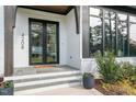 Stylish front entrance boasts a double door entry, painted brick, and elegant outdoor décor at 4208 Windsor Pl, Raleigh, NC 27609