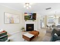 Cozy living room featuring a fireplace, mounted television, and open layout at 4555 Sugarbend Way, Raleigh, NC 27606