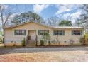 Charming single-story home featuring wood siding, green shutters, and a front porch with wooden steps at 5848 Yates Mill Pond Rd, Raleigh, NC 27606