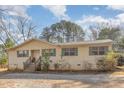 Charming single-story home featuring wood siding, green shutters, and a front porch with wooden steps at 5848 Yates Mill Pond Rd, Raleigh, NC 27606
