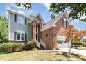 Lovely two-story home featuring a brick facade and a well-maintained front yard with lush greenery at 5915 Eaglesfield Dr, Raleigh, NC 27613