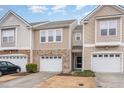 Charming townhome featuring a one-car garage, brick accents, and neutral siding in a well-maintained community at 705 Keystone Park Dr # 51, Morrisville, NC 27560