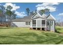 Back exterior view of home with a screened porch and a large manicured backyard at 7112 Camp Side Ct, Raleigh, NC 27613