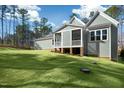 View of screened in back porch and large lawn of backyard of home at 7112 Camp Side Ct, Raleigh, NC 27613