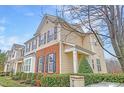 A well-kept multi-story townhome with a mix of vinyl siding and brick, topped with black shutters at 714 Cupola Dr, Raleigh, NC 27603