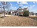 Suburban two-story home with inviting facade, a two-car garage, and a traditional landscaped yard at 714 Fairway Dr, Mebane, NC 27302