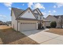 This home features a two-car garage, a well-manicured lawn, and a classic two-story design at 714 Fairway Dr, Mebane, NC 27302
