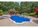 Gorgeous backyard pool with a built-in hot tub, stone accents, and an array of seating areas at 7400 Bleasdale Ct, Apex, NC 27539