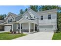 Charming two-story home with a welcoming front porch and well-manicured lawn at 7521 Percussion Dr, Apex, NC 27539