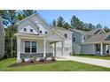 Charming two-story home with a welcoming front porch and well-manicured lawn at 7521 Percussion Dr, Apex, NC 27539