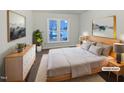 This is a cozy bedroom with a neutral color palette, natural light, and simple decor at 900 Oakwater Dr, Garner, NC 27529