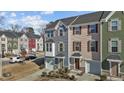 Attractive townhomes with attached garages and well-manicured front lawns in a modern community setting at 905 Arnold Place Dr, Fuquay Varina, NC 27526