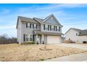 Charming gray two-story house with an attached two-car garage and a well-manicured lawn at 1 Baylis St, Franklinton, NC 27525