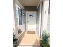A charming front door has a 'hello' sign with two plants on each side of the walkway at 1 Baylis St, Franklinton, NC 27525