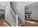 Bright entryway featuring hardwood floors, staircase, and dining room view at 105 Solstice Cir, Cary, NC 27513