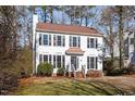 Classic two-story home with white siding, black shutters, and a meticulously maintained front lawn at 105 Solstice Cir, Cary, NC 27513