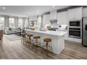 Kitchen boasts a large island with seating, stainless steel appliances, and hard surface floors at 1402 Chowan Ave, Durham, NC 27713