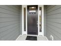 Inviting front door with sidelights, providing natural light and enhancing curb appeal of the home at 1749 Daiquiri Turn, Sanford, NC 27332