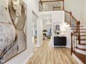 Grand foyer featuring wood floors, staircase, and an open view to the living spaces beyond at 206 Steep Bank Dr, Cary, NC 27518
