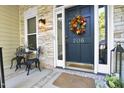 Inviting entryway with a decorative fall wreath on the dark, stately front door at 206 Steep Bank Dr, Cary, NC 27518