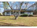 Inviting single-story house with a covered porch, gray siding, and a well-manicured lawn at 245 Cedar Crk Rd, Franklinton, NC 27525