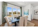 Elegant dining room with large windows providing natural light and views of the outdoors at 2806 Kempthorne Rd # 62, Cary, NC 27519