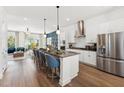 Open-concept kitchen featuring stainless steel appliances, a kitchen island, and stylish pendant lighting at 2812 Kempthorne Rd # 59, Cary, NC 27519